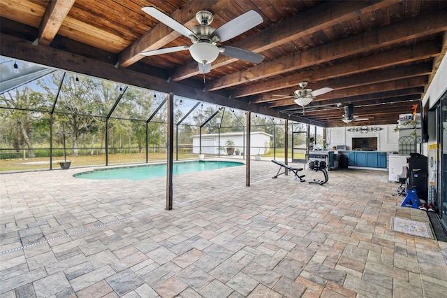 view of pool featuring a lanai, ceiling fan, an outbuilding, and a patio