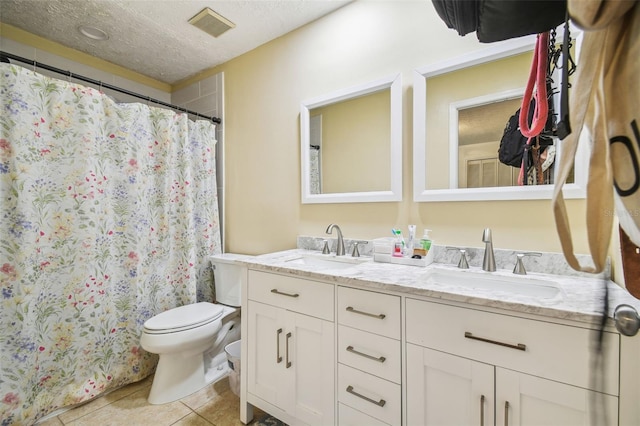 bathroom with toilet, tile patterned flooring, a textured ceiling, a shower with curtain, and vanity