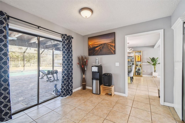 interior space featuring a textured ceiling and light tile patterned floors