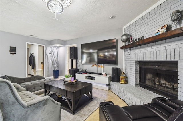 living room featuring a textured ceiling and a fireplace