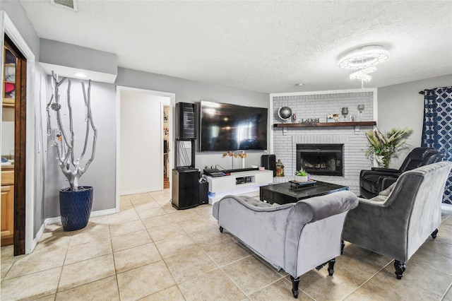 tiled living room with a brick fireplace and a textured ceiling