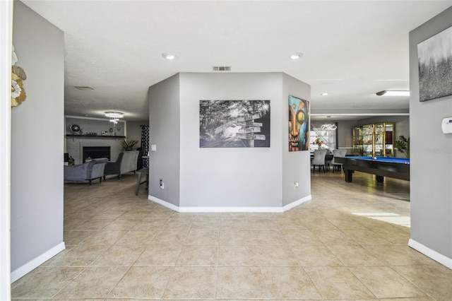 hall featuring light tile patterned floors