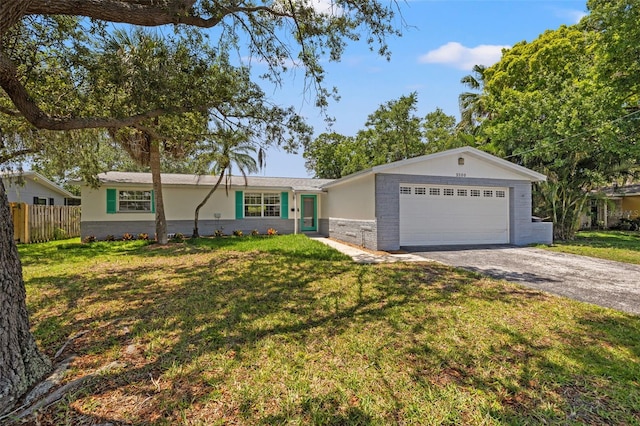 single story home with a front yard and a garage