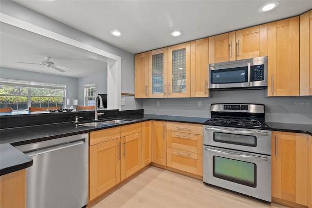 kitchen with light hardwood / wood-style flooring, light brown cabinetry, appliances with stainless steel finishes, ceiling fan, and sink