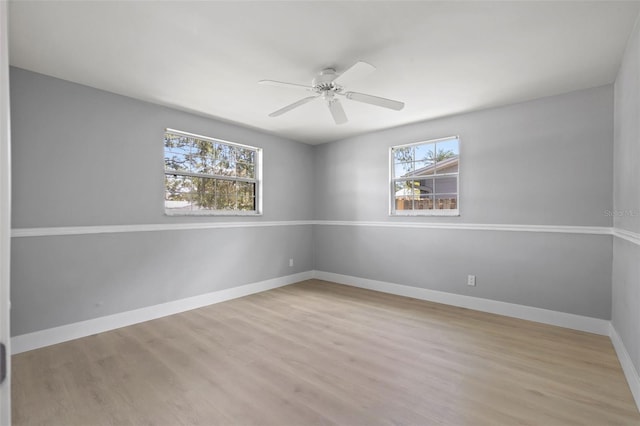 spare room featuring ceiling fan and light hardwood / wood-style flooring