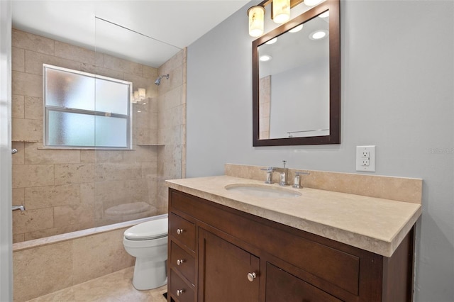 bathroom featuring toilet, tile patterned flooring, tiled shower, and vanity