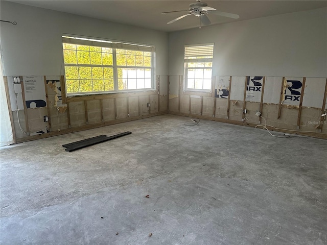 spare room featuring concrete floors and ceiling fan