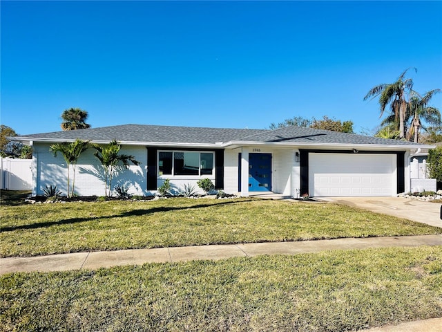 ranch-style home featuring a front lawn and a garage