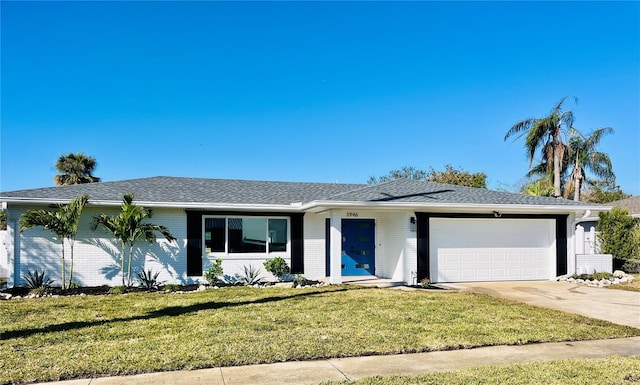 single story home featuring a garage and a front yard