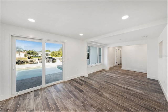 unfurnished room with dark wood-type flooring