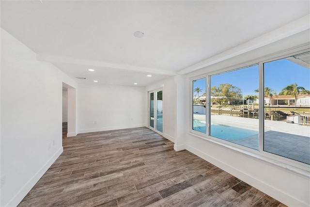 empty room with hardwood / wood-style flooring