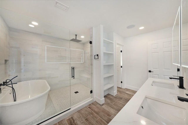 bathroom with vanity and independent shower and bath