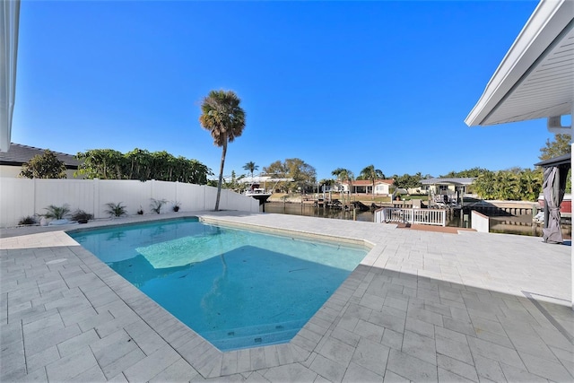 view of pool with a water view and a patio