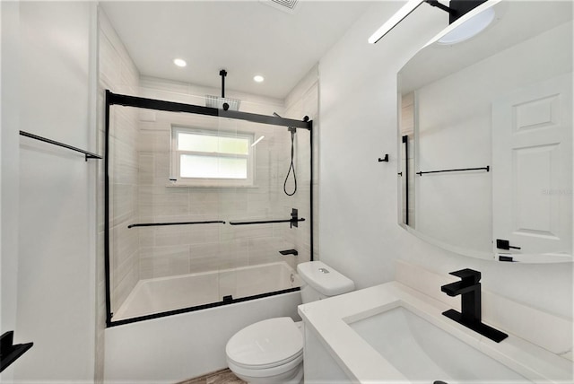 full bathroom with vanity, toilet, and shower / bath combination with glass door