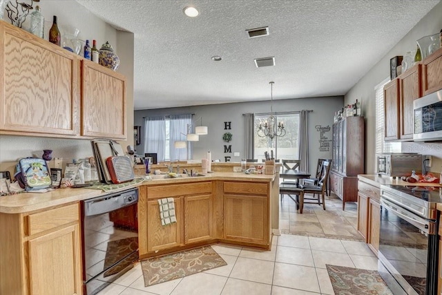 kitchen featuring sink, hanging light fixtures, stainless steel appliances, a chandelier, and light tile patterned floors