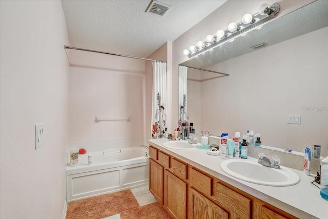 bathroom with tile patterned flooring, vanity, independent shower and bath, and a textured ceiling