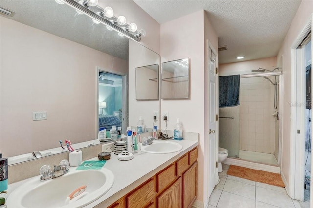 bathroom with tile patterned flooring, a textured ceiling, toilet, a shower with door, and vanity