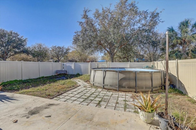 view of patio with a fenced in pool