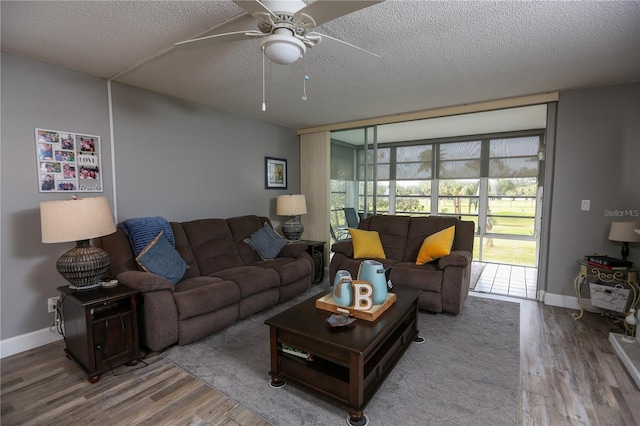 living room with ceiling fan, wood-type flooring, and a textured ceiling