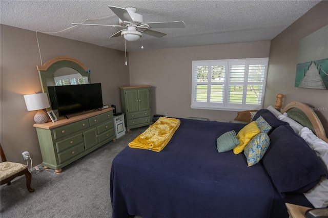 carpeted bedroom featuring ceiling fan and a textured ceiling