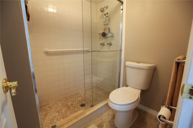 bathroom featuring tile patterned flooring, an enclosed shower, and toilet