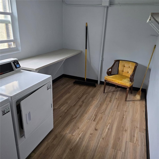 laundry area featuring washer and dryer and wood-type flooring