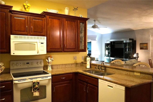 kitchen with ceiling fan, sink, kitchen peninsula, and white appliances