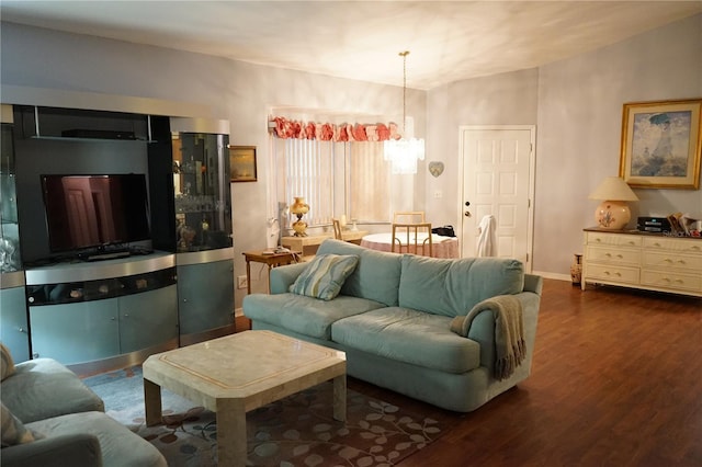 living room featuring dark wood-type flooring and an inviting chandelier