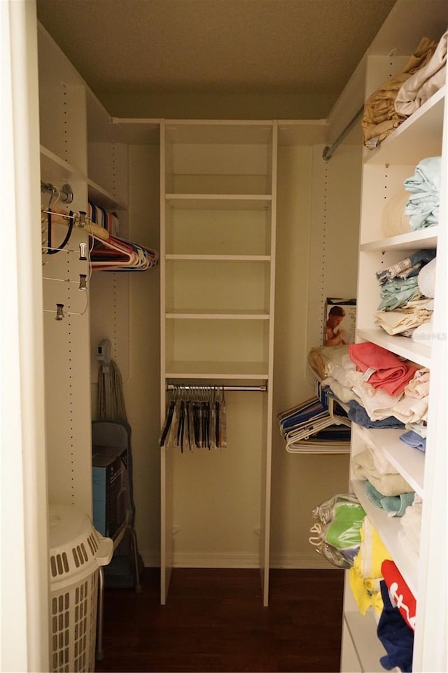 walk in closet featuring dark wood-type flooring