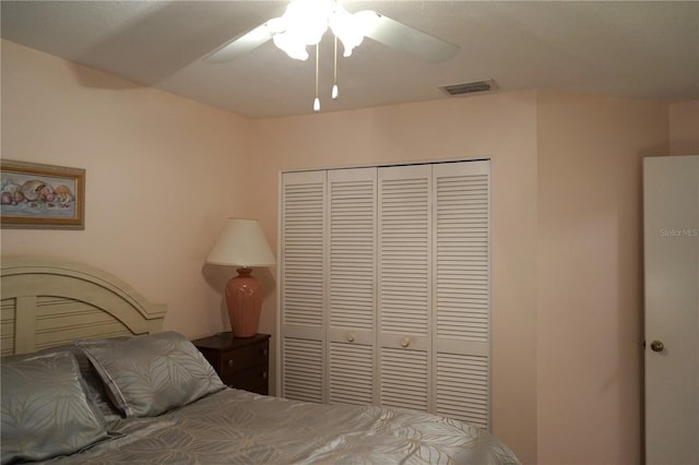 bedroom with ceiling fan and a closet