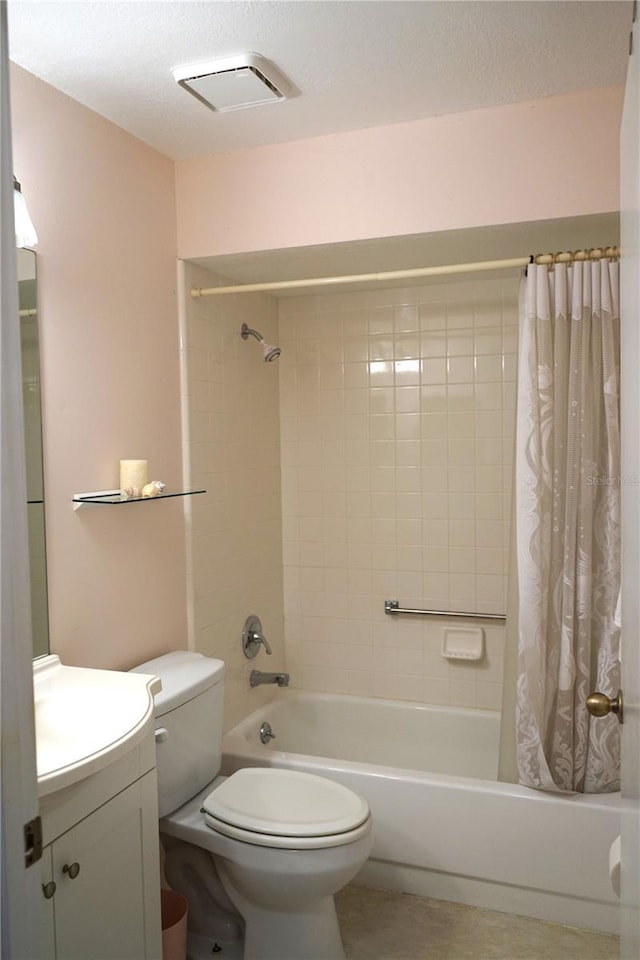 full bathroom with toilet, a textured ceiling, shower / tub combo, and vanity