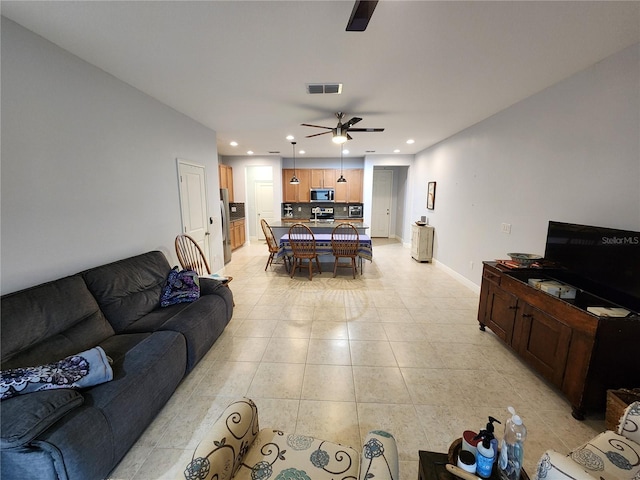 living room featuring ceiling fan and light tile patterned flooring