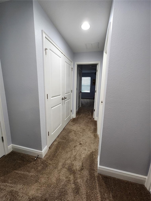 hall with dark carpet