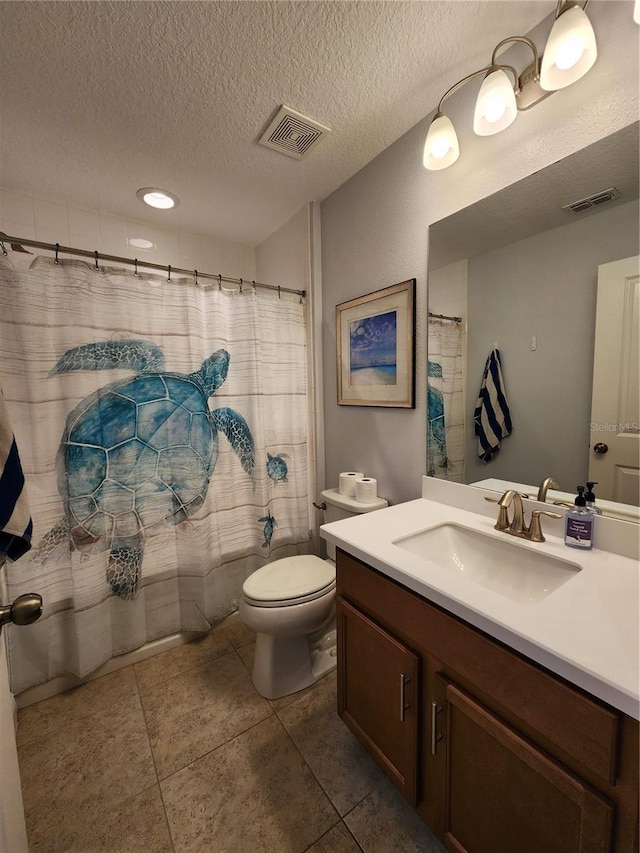 bathroom with toilet, vanity, a shower with shower curtain, and a textured ceiling