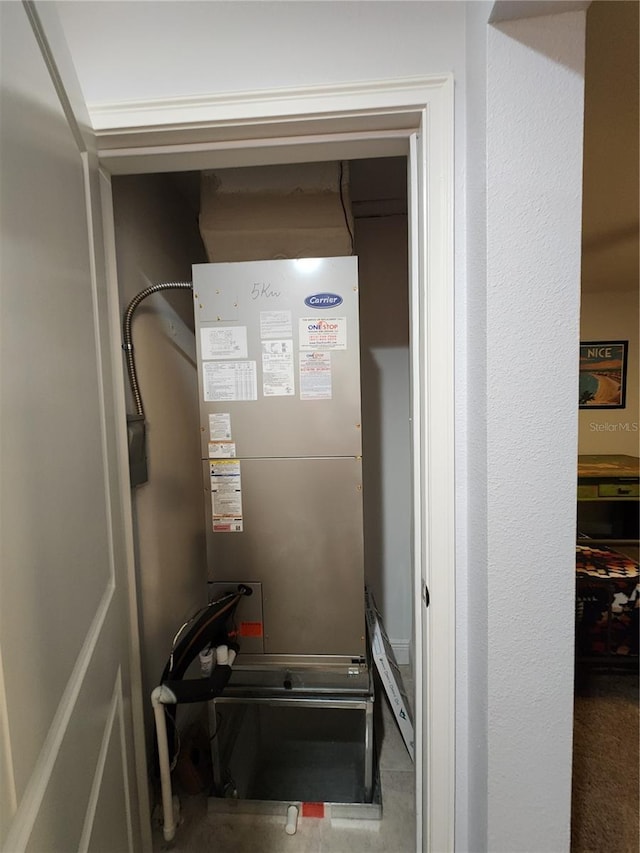 utility room featuring heating unit