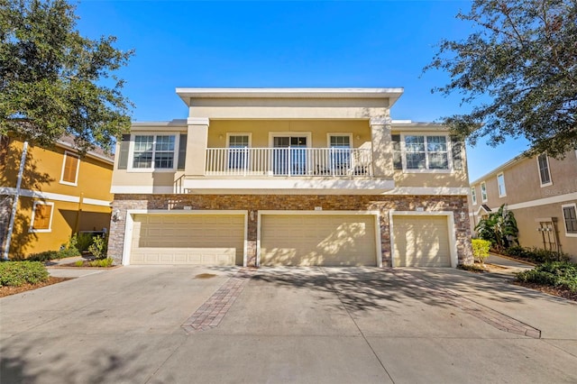 view of front of property with a balcony and a garage