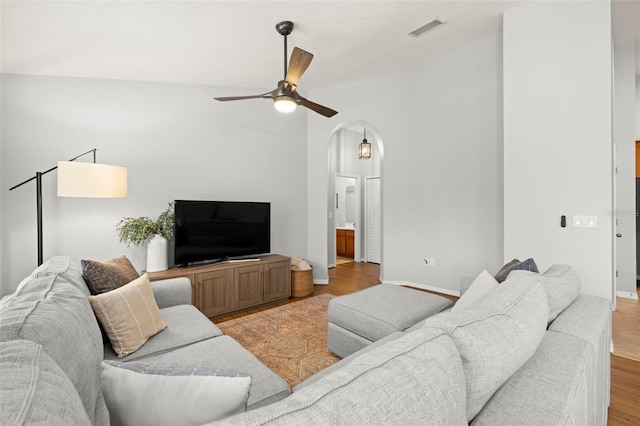 7001 Interbay Blvd Unit 313, Tampa, FL 33616 - living area with visible vents, baseboards, arched walkways, a ceiling fan, and light wood-style flooring