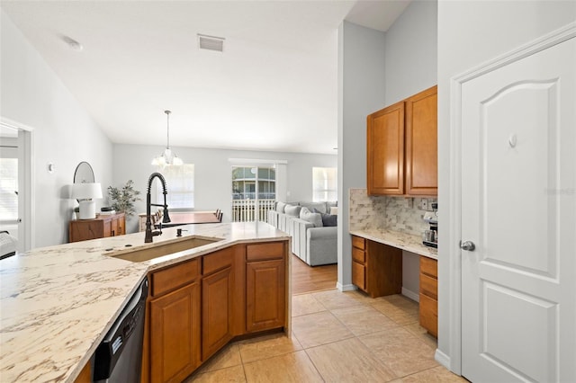 7001 Interbay Blvd Unit 313, Tampa, FL 33616 - kitchen with brown cabinets, open floor plan, dishwashing machine, and light stone countertops