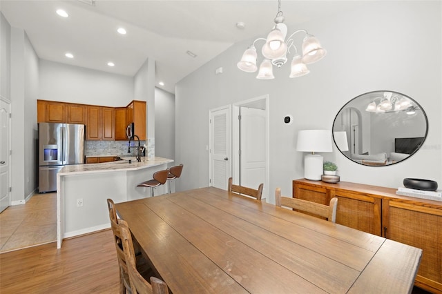 7001 Interbay Blvd Unit 313, Tampa, FL 33616 - dining space with a chandelier, light wood-type flooring, lofted ceiling, and recessed lighting