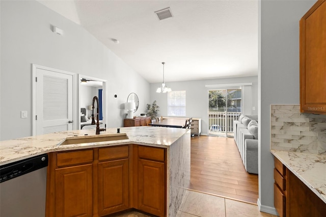 7001 Interbay Blvd Unit 313, Tampa, FL 33616 - kitchen featuring dishwasher, light stone countertops, brown cabinetry, and high vaulted ceiling