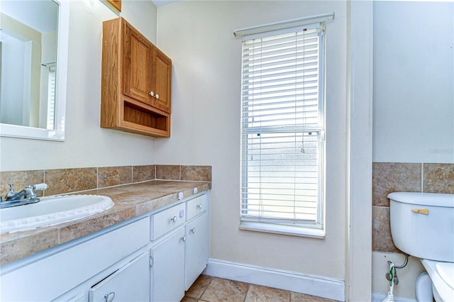 bathroom featuring tile patterned flooring, vanity, and toilet