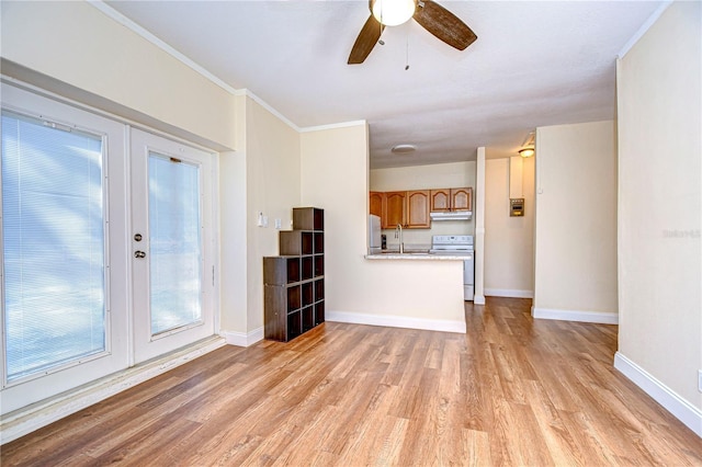 unfurnished living room with ceiling fan, french doors, sink, light hardwood / wood-style floors, and ornamental molding