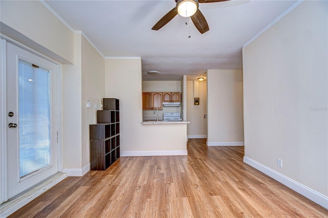 unfurnished living room featuring light wood-type flooring, ceiling fan, and crown molding