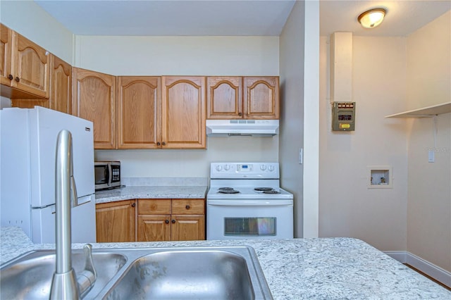 kitchen featuring brown cabinets, white appliances, light countertops, baseboards, and under cabinet range hood
