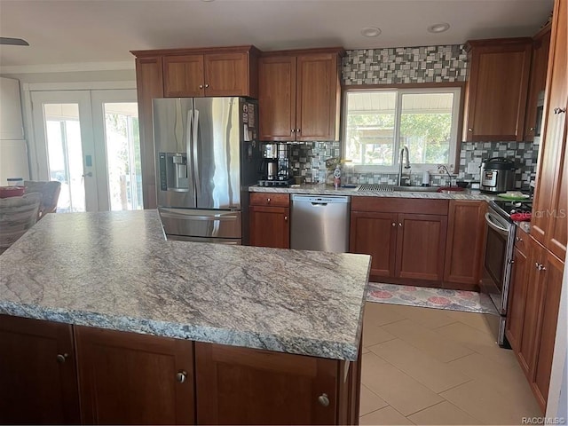 kitchen featuring plenty of natural light, sink, stainless steel appliances, and french doors