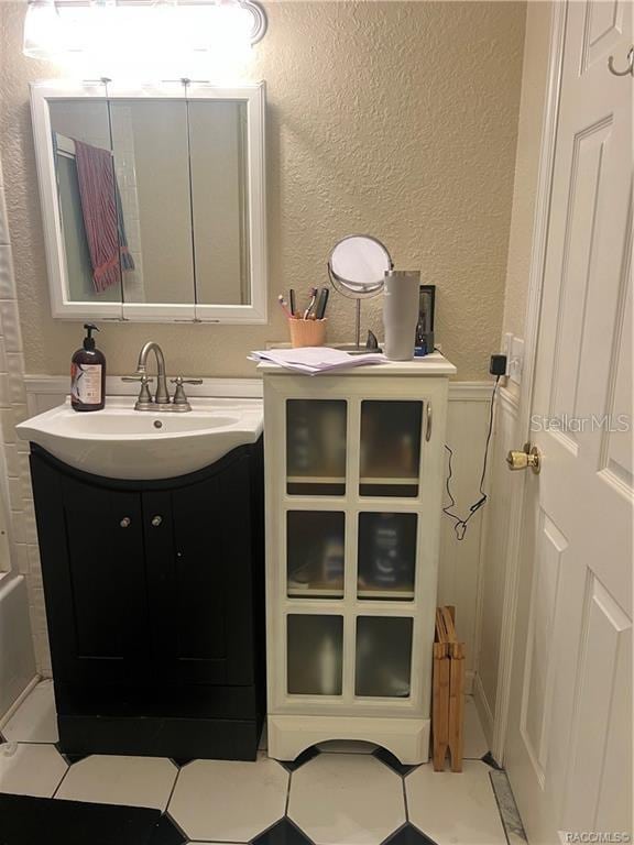 bathroom with tile patterned floors and vanity