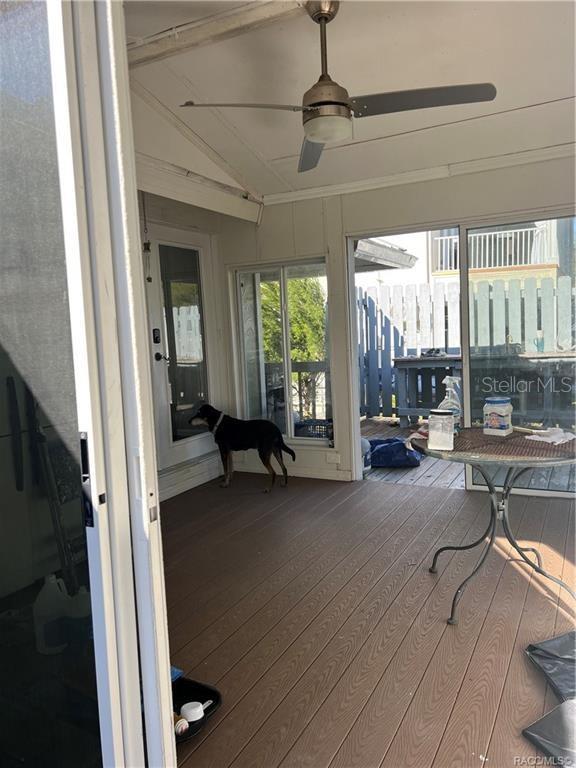 sunroom featuring ceiling fan and lofted ceiling