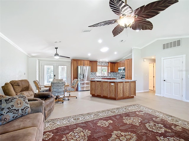 living room featuring vaulted ceiling, light tile patterned floors, ceiling fan, crown molding, and french doors