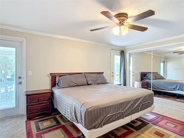 carpeted bedroom featuring ceiling fan, ornamental molding, multiple windows, and access to exterior