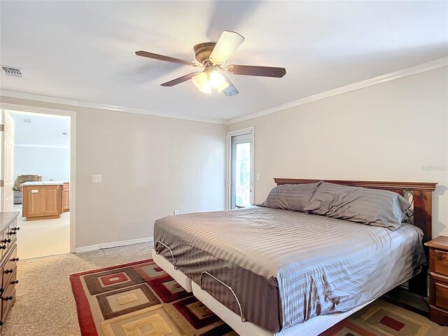 bedroom featuring ceiling fan, crown molding, and light colored carpet